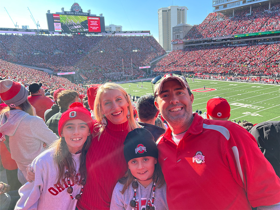 Frank LaRose at a football game with his wife and children